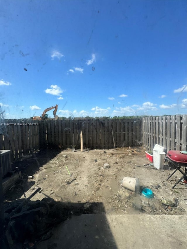 view of yard with fence and cooling unit