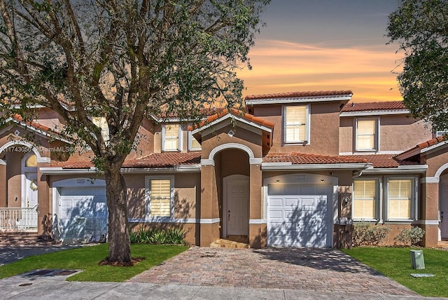 mediterranean / spanish house featuring a garage