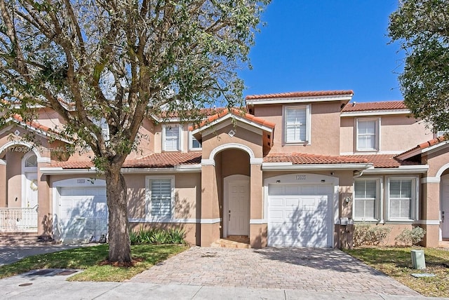 mediterranean / spanish-style house with a garage