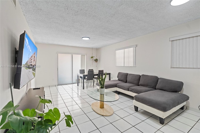 living area featuring light tile patterned floors and a textured ceiling