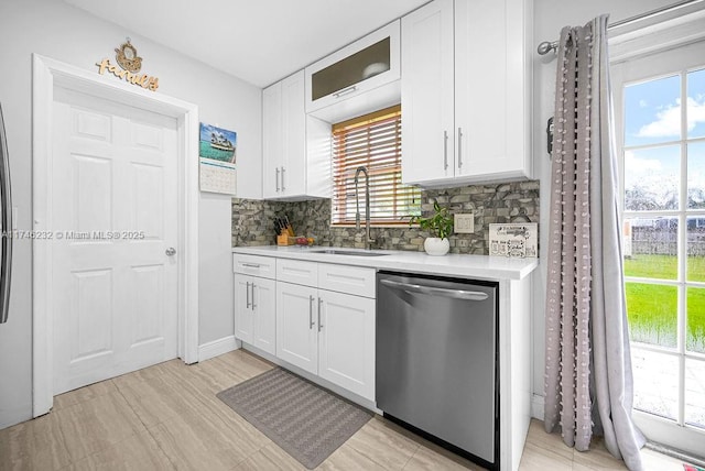 713 SW 6th Ave, Hallandale Beach, FL 33009 - kitchen featuring sink, decorative backsplash, white cabinets, and dishwasher