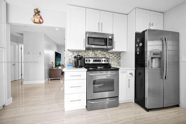 713 SW 6th Ave, Hallandale Beach, FL 33009 - kitchen with white cabinetry, backsplash, and appliances with stainless steel finishes