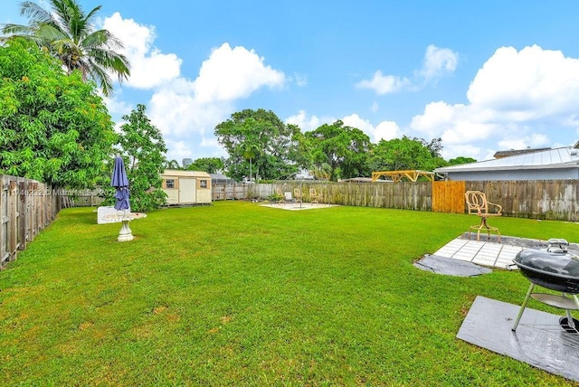 713 SW 6th Ave, Hallandale Beach, FL 33009 - view of yard featuring a storage shed and a patio area