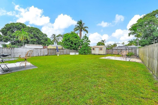 713 SW 6th Ave, Hallandale Beach, FL 33009 - view of yard featuring a patio and a shed