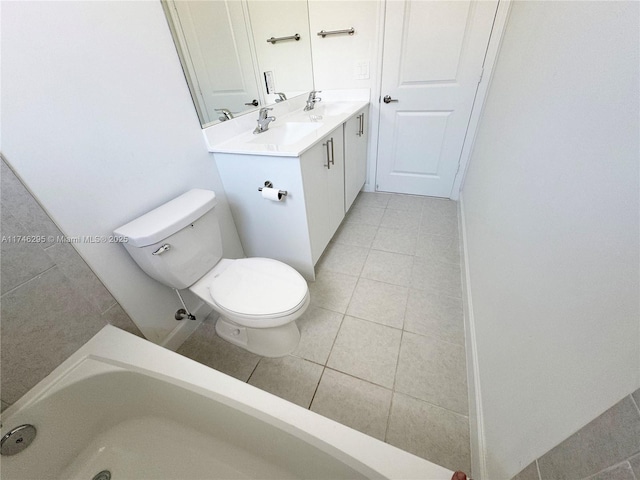 bathroom with vanity, tile patterned flooring, and toilet