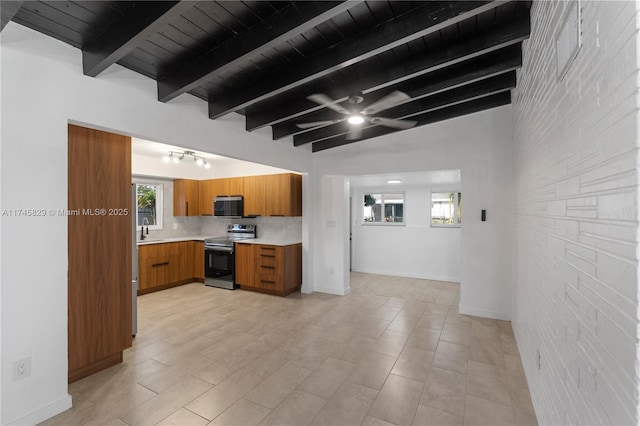 kitchen featuring tasteful backsplash, lofted ceiling with beams, sink, wood ceiling, and stainless steel appliances