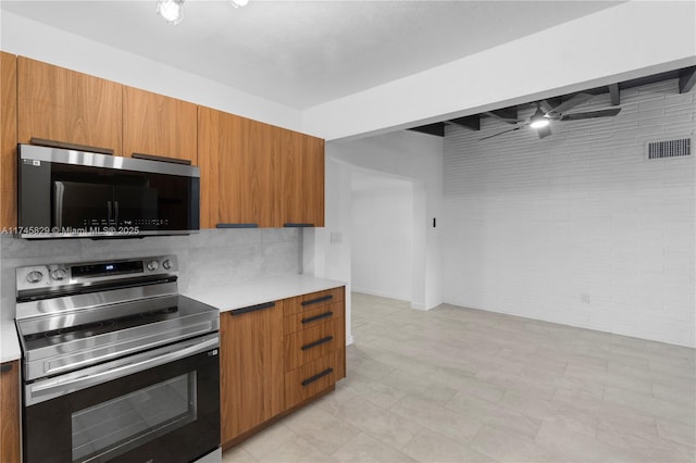 kitchen featuring tasteful backsplash, stainless steel appliances, and beam ceiling