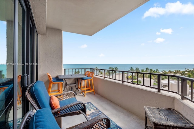 balcony with a water view and a sunroom