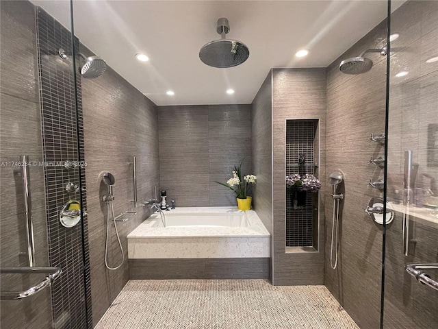 bathroom with tile walls, tile patterned flooring, and independent shower and bath