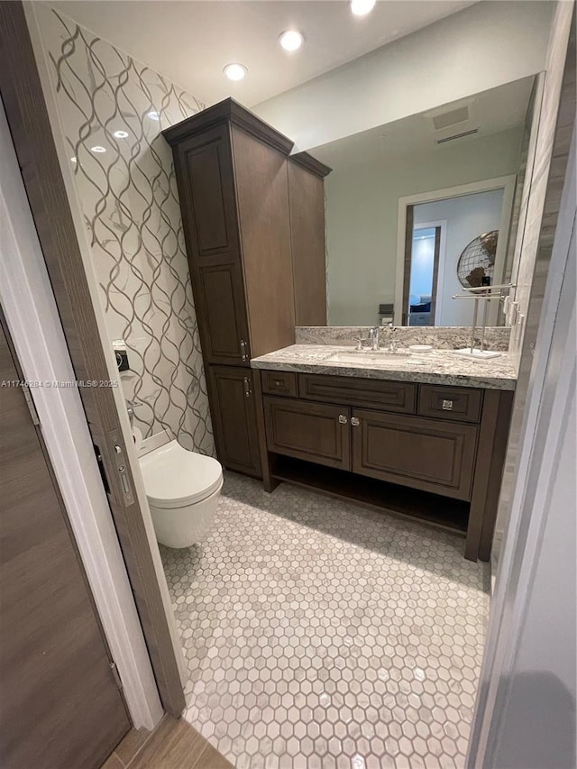 bathroom featuring vanity and toilet