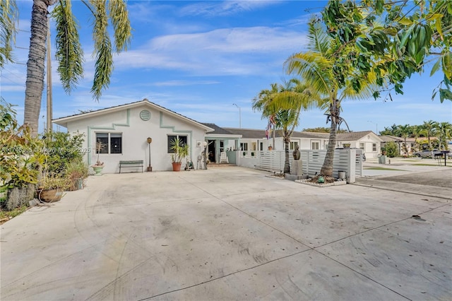 view of front of property with fence and stucco siding