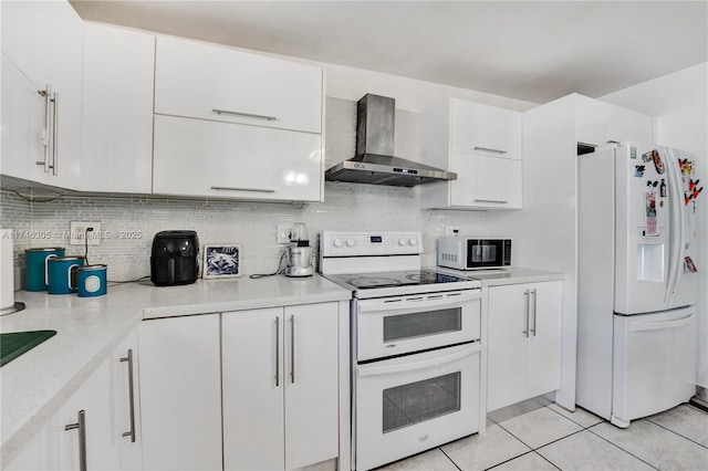 881 SW 137th Ct, Miami, FL 33184 - kitchen featuring tasteful backsplash, light countertops, white cabinets, wall chimney range hood, and white appliances