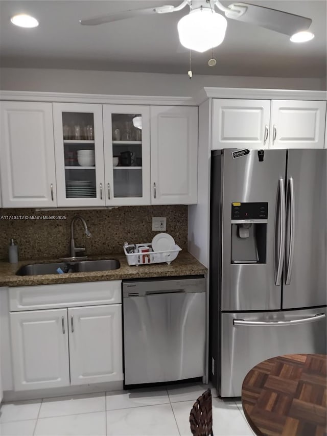 kitchen featuring white cabinets, stainless steel appliances, and a sink