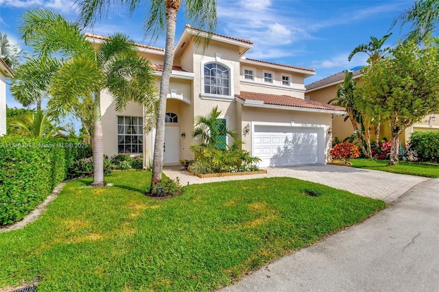 mediterranean / spanish house featuring a garage and a front lawn