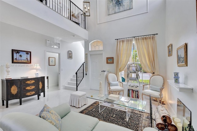 1826 Capeside Cir, Wellington, FL 33414 - living area with a high ceiling, stairway, baseboards, and a chandelier