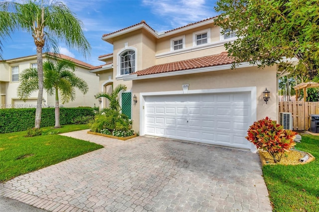 1826 Capeside Cir, Wellington, FL 33414 - mediterranean / spanish-style home with stucco siding, decorative driveway, a tiled roof, and an attached garage