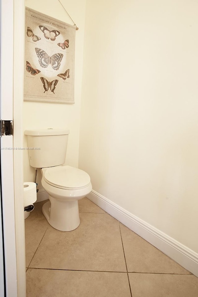 bathroom featuring toilet and tile patterned flooring