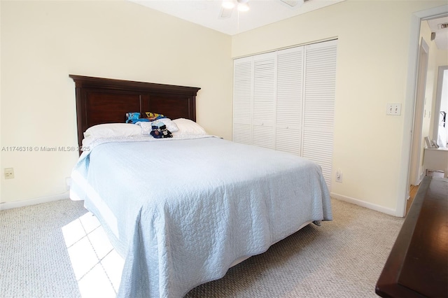 carpeted bedroom featuring ceiling fan and a closet