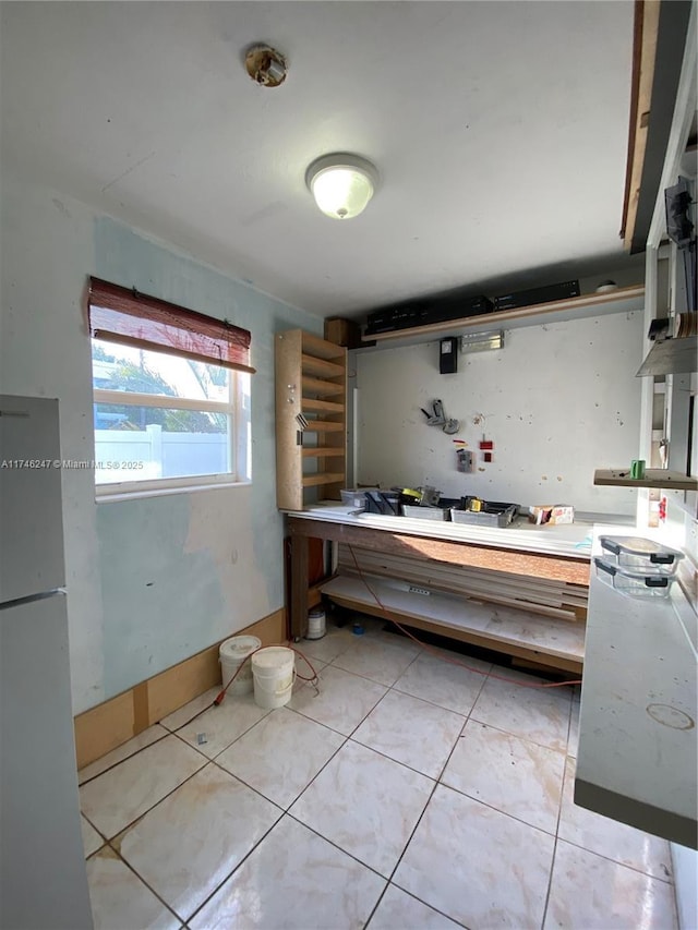 kitchen featuring white refrigerator and light tile patterned flooring