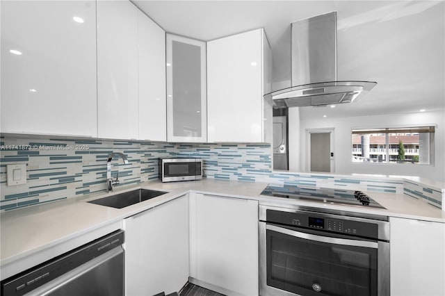 kitchen with stainless steel appliances, white cabinetry, sink, and island exhaust hood