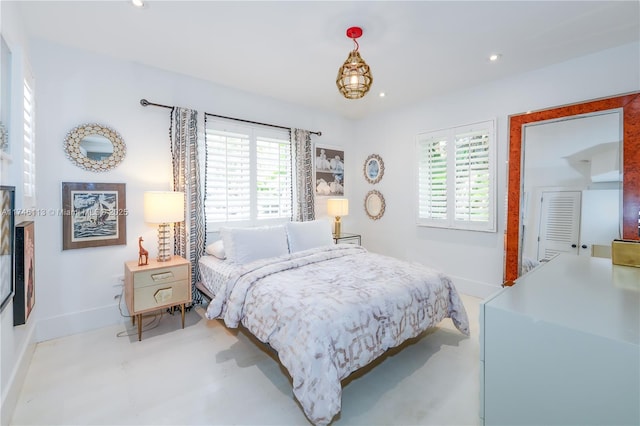 bedroom featuring baseboards, multiple windows, and recessed lighting