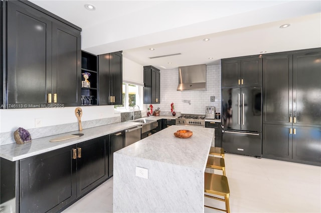 kitchen featuring a center island, open shelves, a sink, wall chimney range hood, and high quality appliances