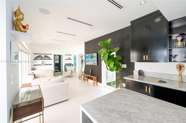 kitchen featuring light countertops, visible vents, and dark cabinets