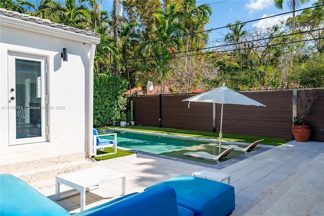 view of patio / terrace featuring a fenced backyard and a fenced in pool