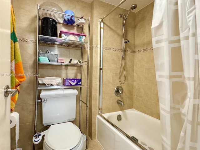 bathroom with tile walls, shower / bath combination with curtain, and toilet