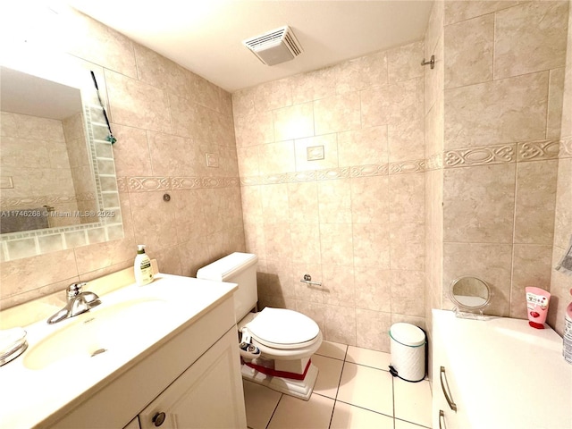 bathroom featuring tile walls, vanity, tile patterned floors, and toilet