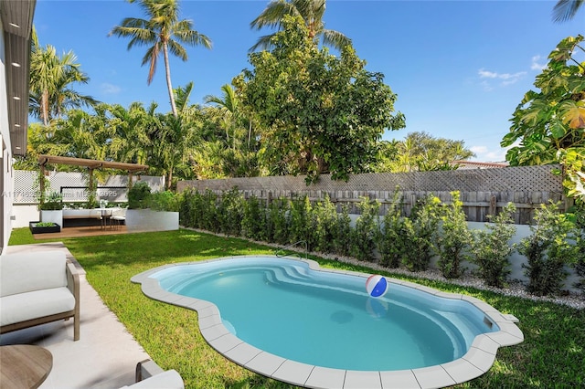 view of pool with a yard, a fenced backyard, and a patio