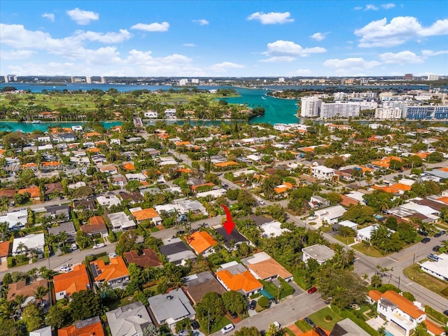 birds eye view of property with a water view and a city view