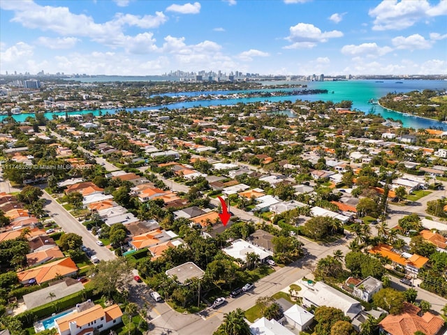 birds eye view of property with a water view and a view of city