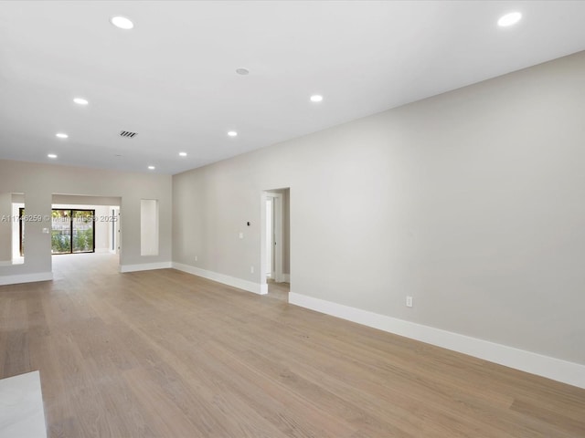 unfurnished living room with light wood-type flooring, visible vents, and recessed lighting