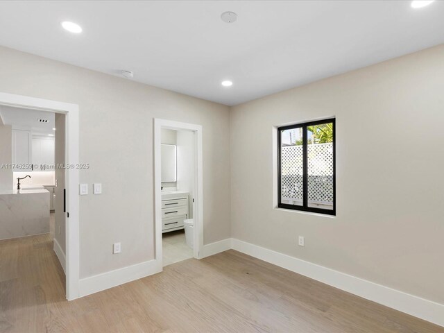 unfurnished living room with baseboards, light wood-style flooring, visible vents, and recessed lighting