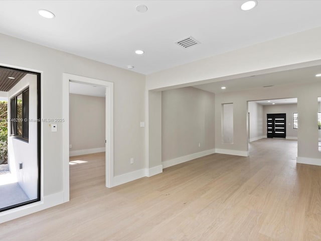 spare room featuring light wood-type flooring, visible vents, and recessed lighting