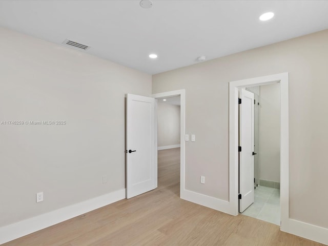 unfurnished bedroom featuring baseboards, recessed lighting, visible vents, and light wood-style floors