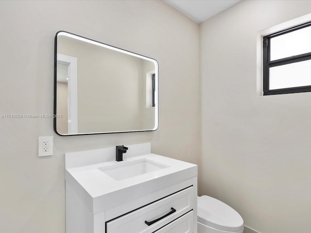 bathroom featuring toilet and vanity