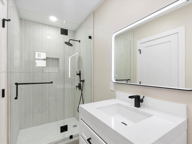 full bathroom with a shower stall and vanity