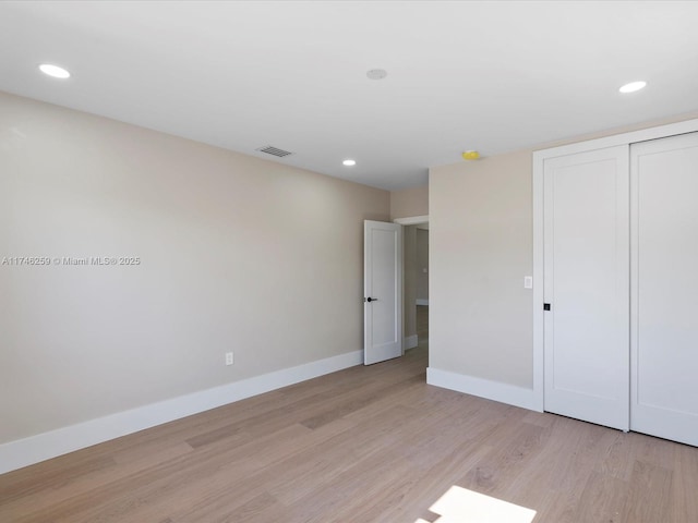 unfurnished bedroom with recessed lighting, a closet, baseboards, and light wood finished floors