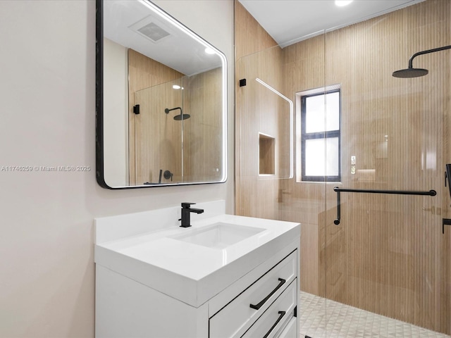 full bath featuring a stall shower, visible vents, and vanity