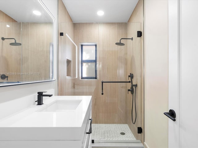 bathroom featuring a stall shower and vanity