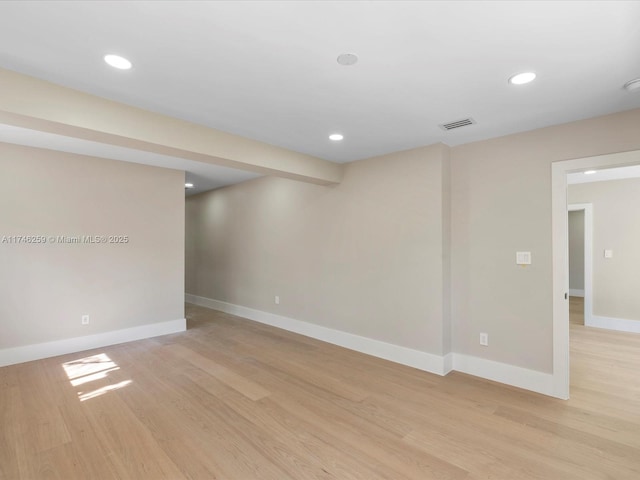 below grade area with light wood-style floors, baseboards, visible vents, and recessed lighting