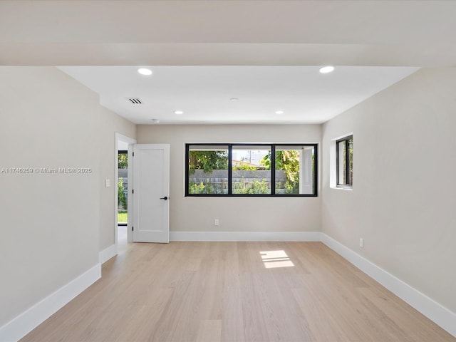 spare room with light wood-style floors, recessed lighting, visible vents, and baseboards