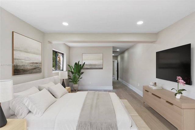 bedroom with baseboards, light wood finished floors, and recessed lighting