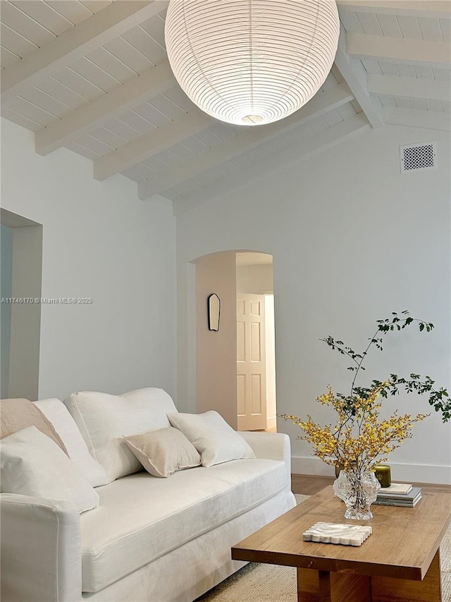 living room with vaulted ceiling with beams and wooden ceiling