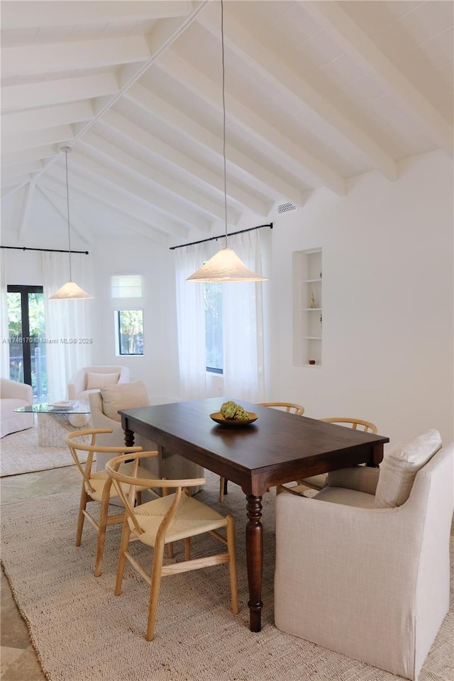 dining space featuring breakfast area and lofted ceiling with beams