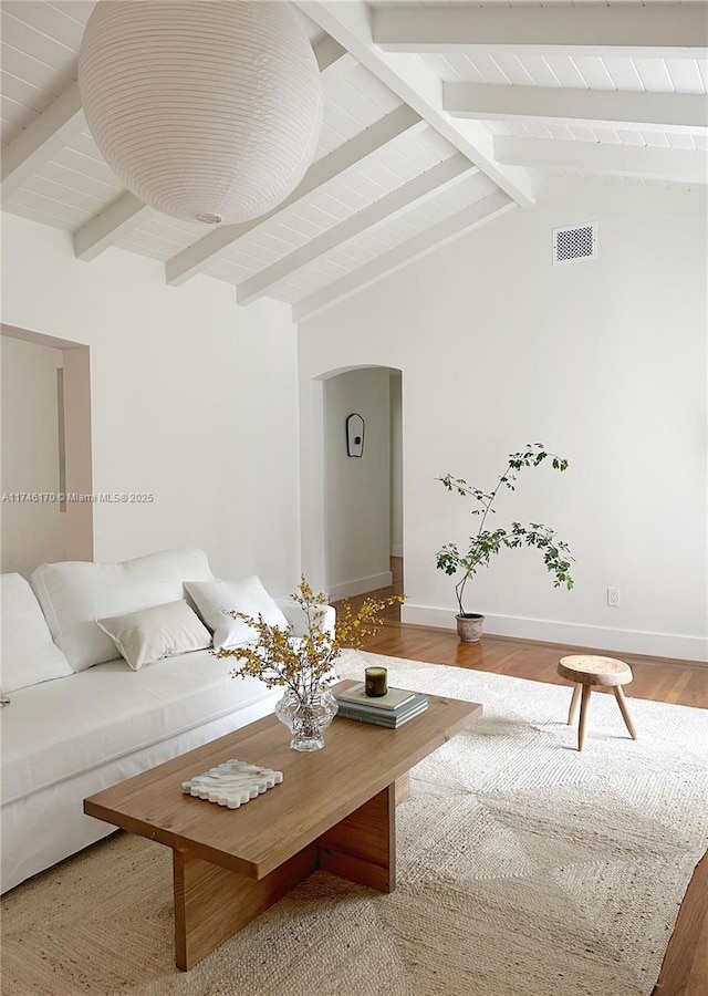 living room with wood-type flooring and lofted ceiling with beams