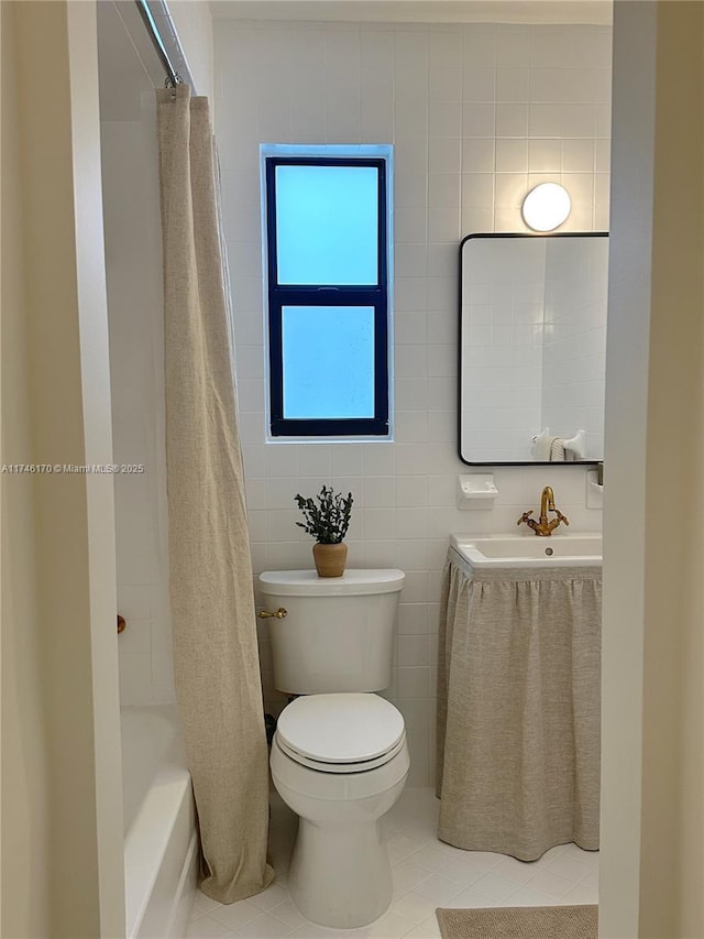 full bathroom featuring toilet, sink, shower / tub combo, tile walls, and tile patterned flooring