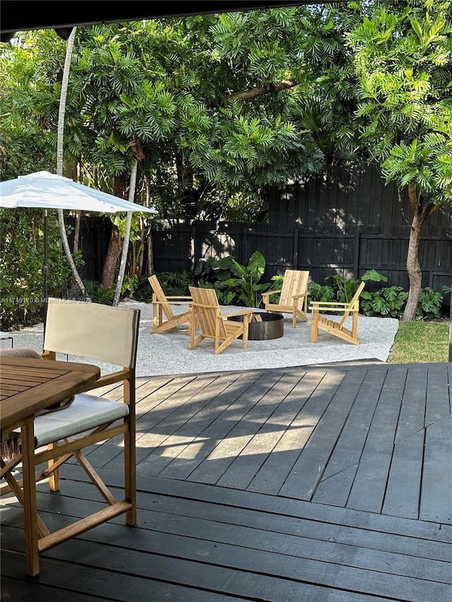 wooden terrace featuring a fire pit